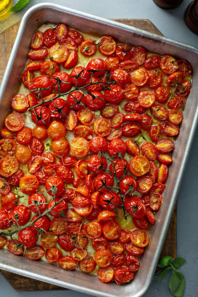 Cherry tomatoes roasted with garlic and spices on a tray
