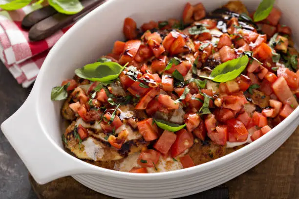 Bruschetta chicken breast with tomatoes and balsamic in a casserole dish