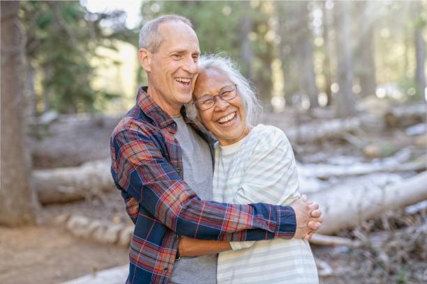 istock Happy retired couple adventuring in forest 1325292441