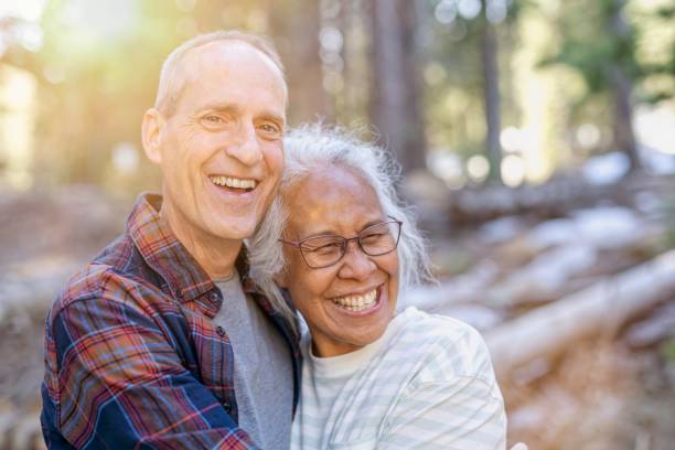 istock Happy senior couple adventuring in forest 1325292444