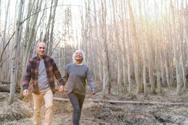 istock Affectionate mixed race senior couple hiking in forest 1325292459