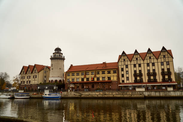 City lighthouse among buildings in the city of Kaliningrad from the side of the river. Observation deck house on the shore of the reservoir. Kaliningrad, Russia November 15, 2019 City lighthouse among buildings from the side of the river. Observation deck house on the shore of the reservoir. The architecture of old houses. kaliningrad stock pictures, royalty-free photos & images