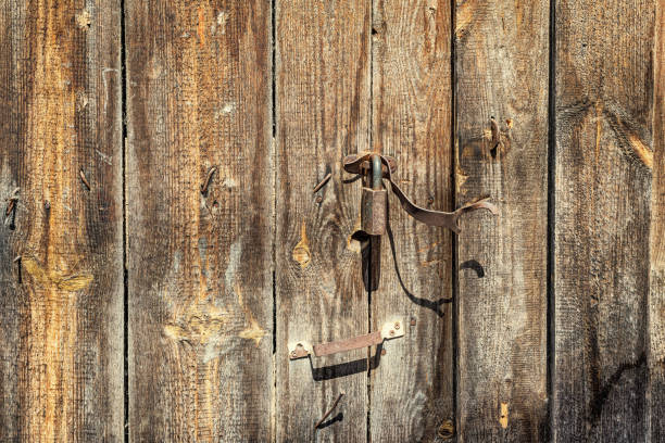 istock An old wooden gate with a rusty lock, background. 1325294657