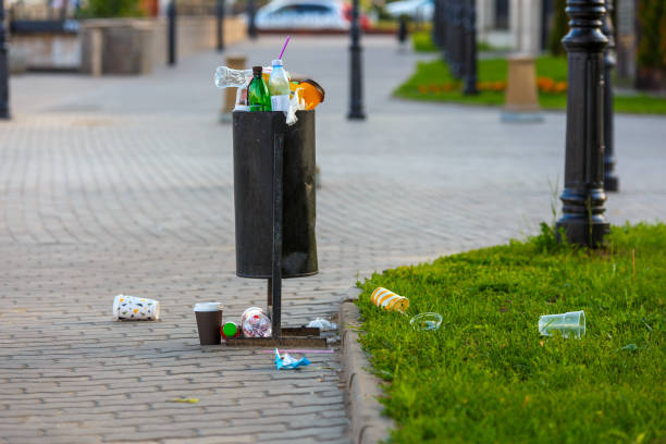 istock overflowing trash can on the sidewalk pavement at summer daylight 1325299957