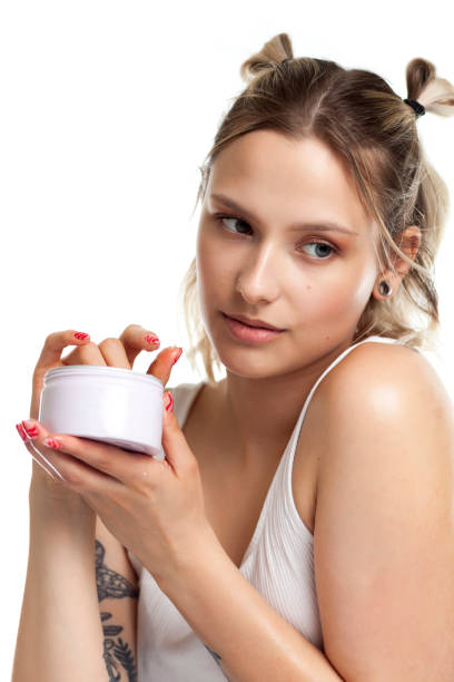 istock Young Woman Applying Soft Natural Cream 1325303198