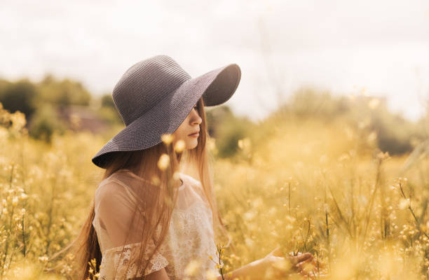 istock A young girl in a hat walks on a rapeseed field. 1325304149