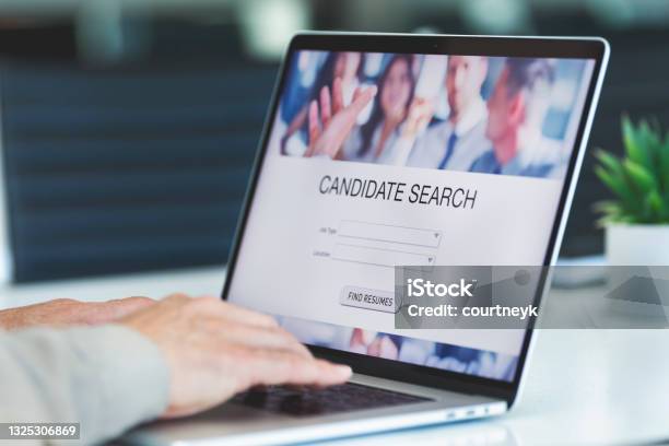 Businessman Looking At Recruitment Website On A Laptop Computer Stock Photo - Download Image Now
