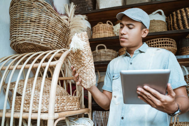istock young entrepreneur checks a woven bag while holding a pad 1325306952