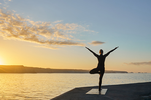 yoga pose of the tree in silhouette of a woman