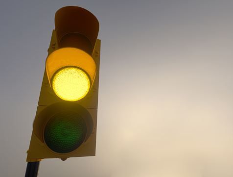 Outdoor vertical traffic light. Traffic control concept image with shallow depth of field.