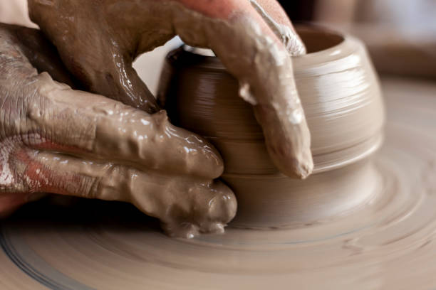istock Hands of a potter working on a lathe 1325313583