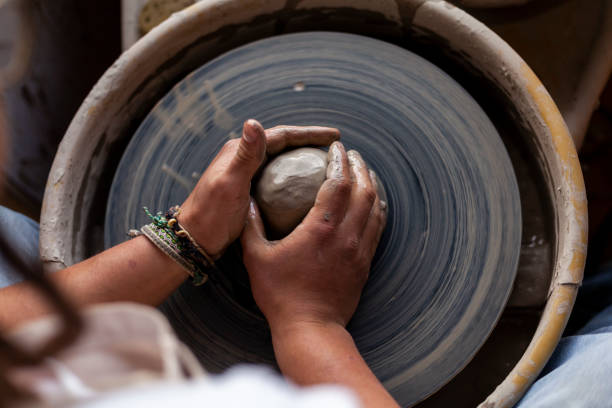 istock Hands of a potter working on a lathe 1325313586