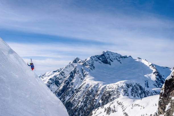 istock Backcountry skier hikes up snowy mountain slope 1325314314