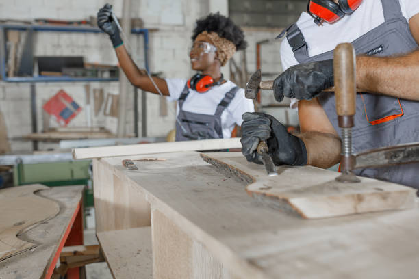 istock A Carpenter with Protective Workwear is Working in Carpentry Workshop with his Colleagues. 1325315101