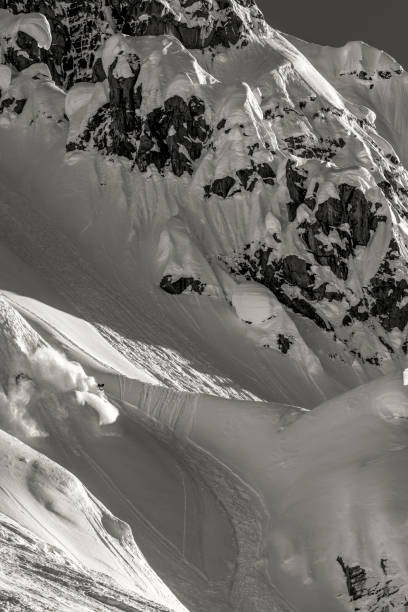istock Extreme skier descends mountain through powder snow 1325315117