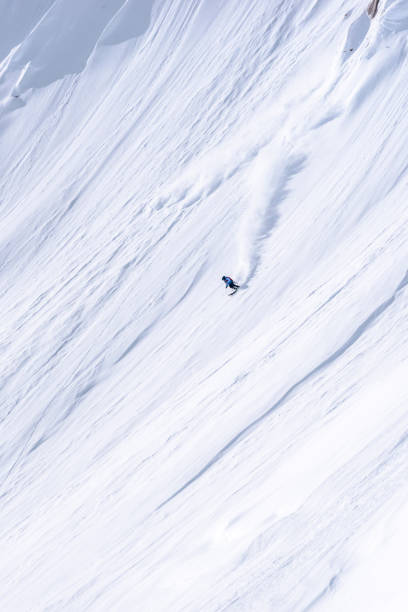 istock Extreme skier descends mountain through powder snow 1325315199