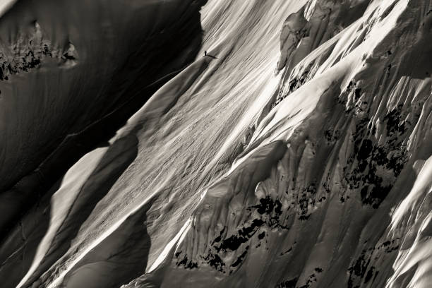 istock Extreme skier descends mountain through powder snow 1325315212