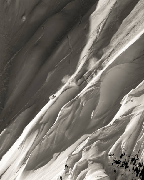 istock Extreme skier descends mountain through powder snow 1325315214