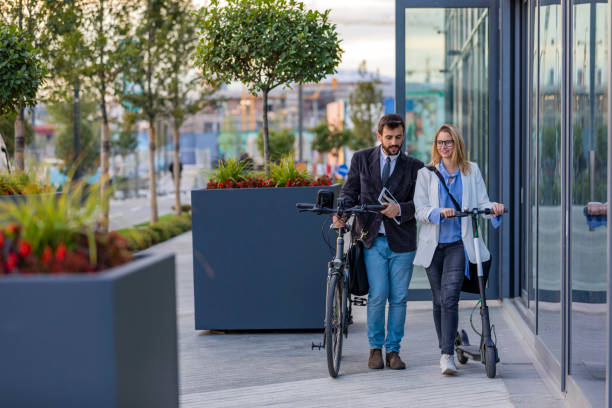 smiling business couple outdoors in the street. business communication between young couple. - cycling bicycle women city life imagens e fotografias de stock