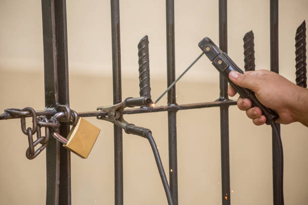 istock man using welding a piece of iron in an outdoor gate 1325323230
