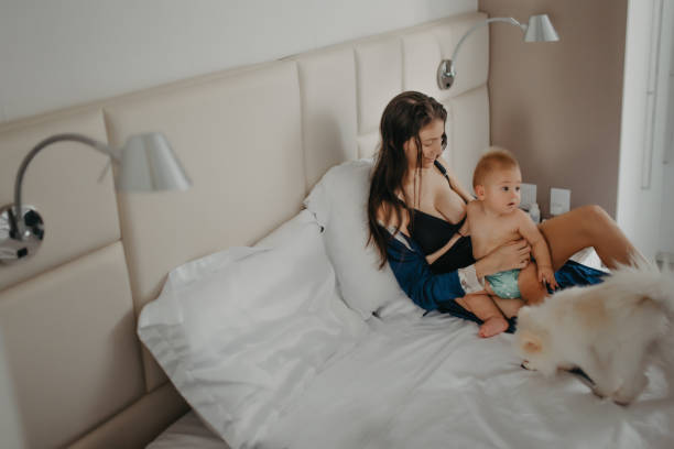 istock mother breastfeeding baby in bed 1325328210