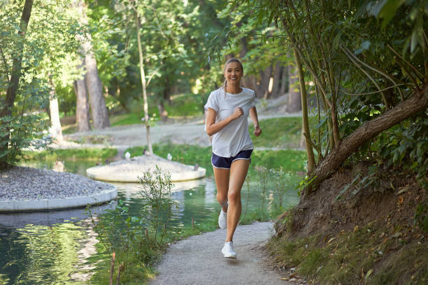istock Woman running road summer park 1325328251