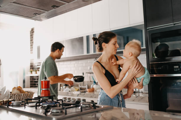 istock baby parents preparing food in the kitchen 1325328807