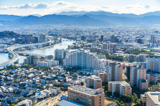 Modern city skyline aerial view in Fukuoka, Japan Asia Business concept for real estate and corporate construction - panoramic urban city aerial view under bright blue sky and sun in Fukuoka Japan fukuoka city photos stock pictures, royalty-free photos & images