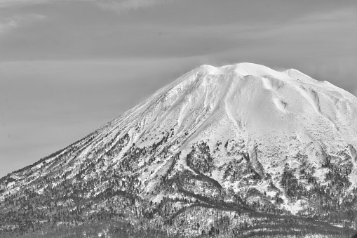 Monochrome winter landscape - snowcapped volcano on a clear day