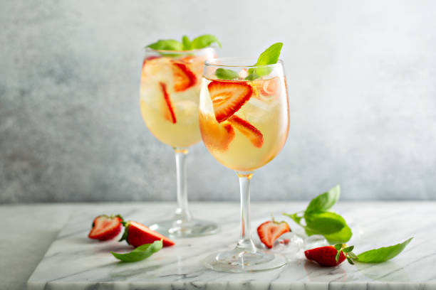 Summer white sangria with strawberries Summer white sangria with strawberries and basil sangria stock pictures, royalty-free photos & images