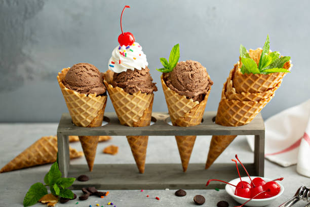 Chocolate ice cream in waffle cones Chocolate ice cream in waffle cones with whipped cream and sprinkles Ice Cream Cone stock pictures, royalty-free photos & images