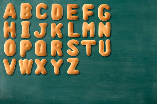 istock Uppercase alphabetical order in biscuits on blackboard with copy space 1325337102