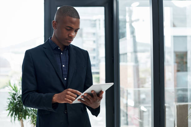 istock Shot of a young businessman using a digital tablet in a modern office 1325337794
