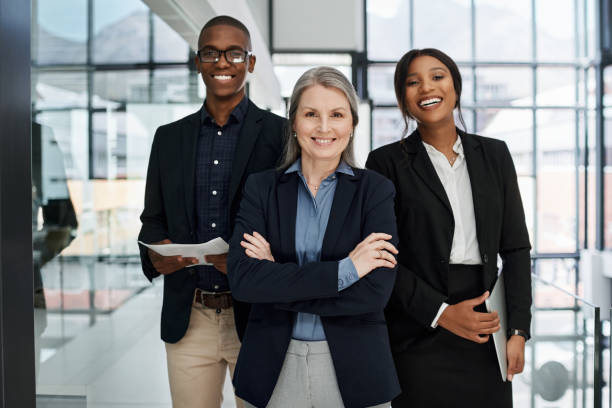 retrato de un grupo de empresarios que trabajan juntos en una oficina moderna - three people group of people standing business person fotografías e imágenes de stock