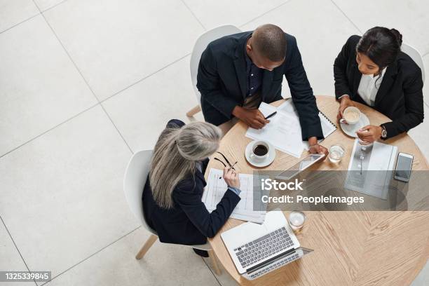 High Angle Shot Of A Group Of Businesspeople Having A Meeting In A Modern Office Stock Photo - Download Image Now