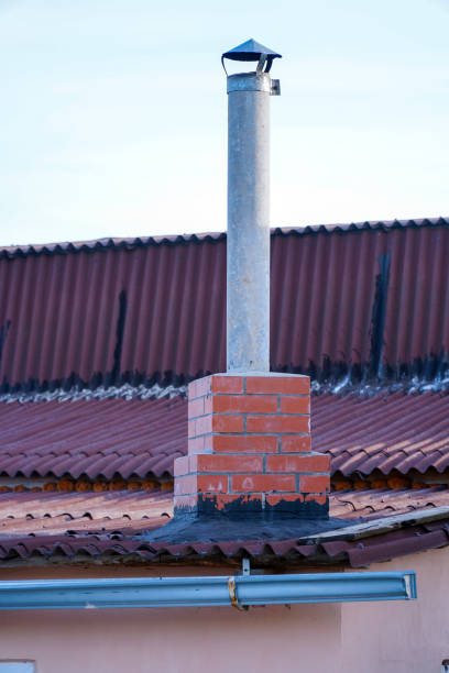 istock Pipe chimney on the roof against light sky 1325344482