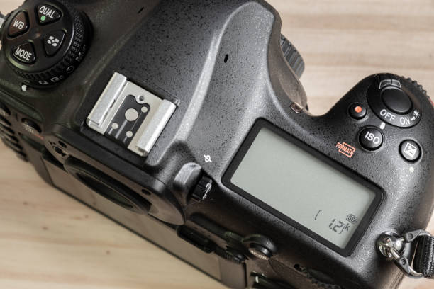 istock DSLR camera overhead view, second LCD display on the top, switched off state. mode dials and hot shoe close-up photograph. 1325345500