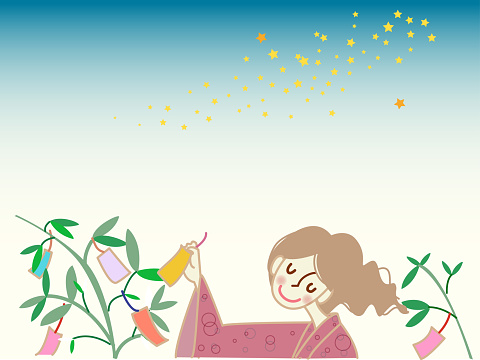 A woman who writes a wish on the bamboo grass of Tanabata.