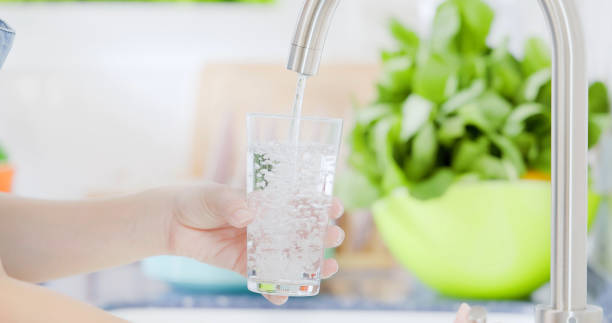 istock water from tap into glass 1325348556