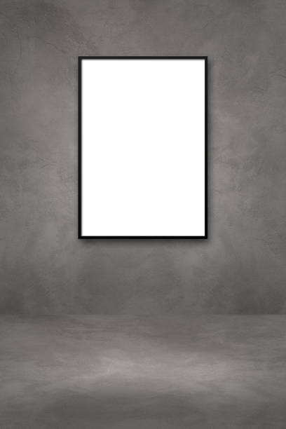 istock Black picture frame hanging on a dark concrete wall 1325348716