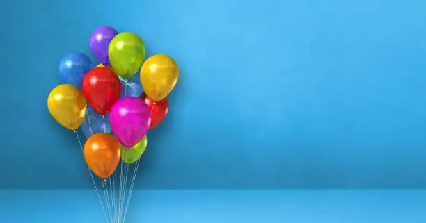 Colorful balloons bunch on a blue wall background. Horizontal banner. 3D illustration render