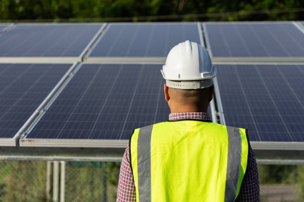 istock Young asian electrical engineer standing in front of Solar cell panels farm. He checking and installing. Solar generator power concept. 1325350266