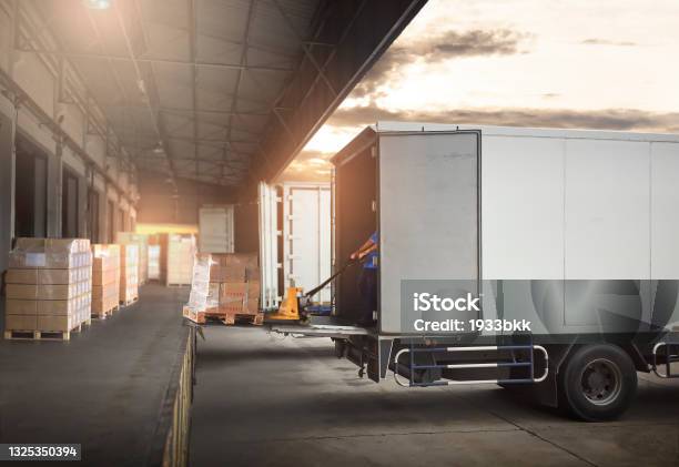 Package Boxes On Pallets Loading Into Cargo Container Trucks Parked Loading At Dock Warehouse Delivery Service Shipping Warehouse Logistics Road Freight Truck Transportation Stock Photo - Download Image Now