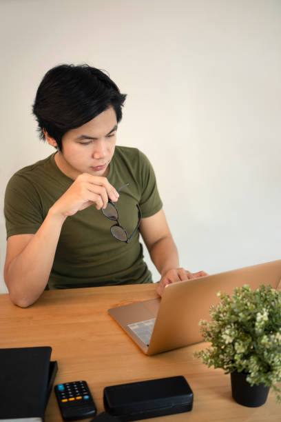 istock Serious man freelancer working online with laptop at home. 1325351638