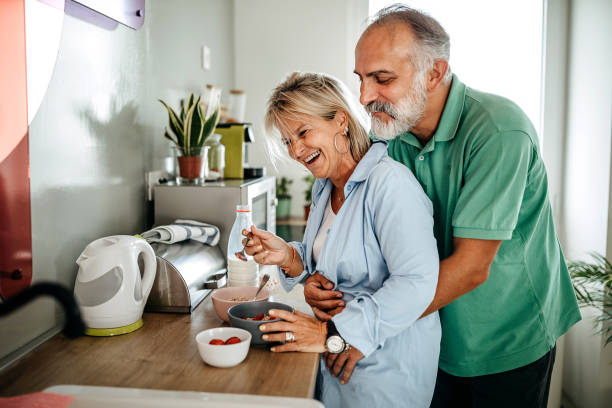 istock Senior man and woman preparing breakfast together 1325352818