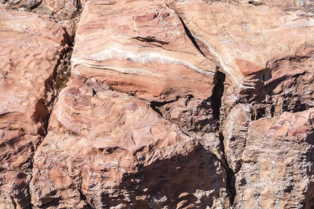 istock Unique colorful pattern of crumbling rock with deep cracks. Texture and natural background of sandstone. 1325354687