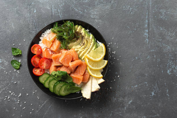 istock Poke bowl with salmon, avocado and vegetables top view 1325355420