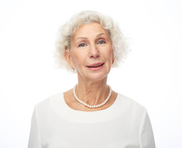 istock Happy senior woman isolated over white background 1325355497