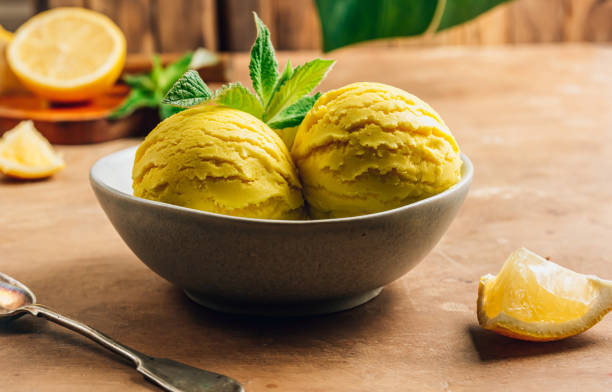 istock Scoops of lemon ice cream in a bowl on rustic table. 1325355808