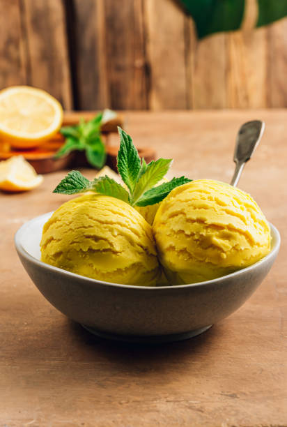 istock Scoops of lemon ice cream in a bowl on rustic table. 1325355813